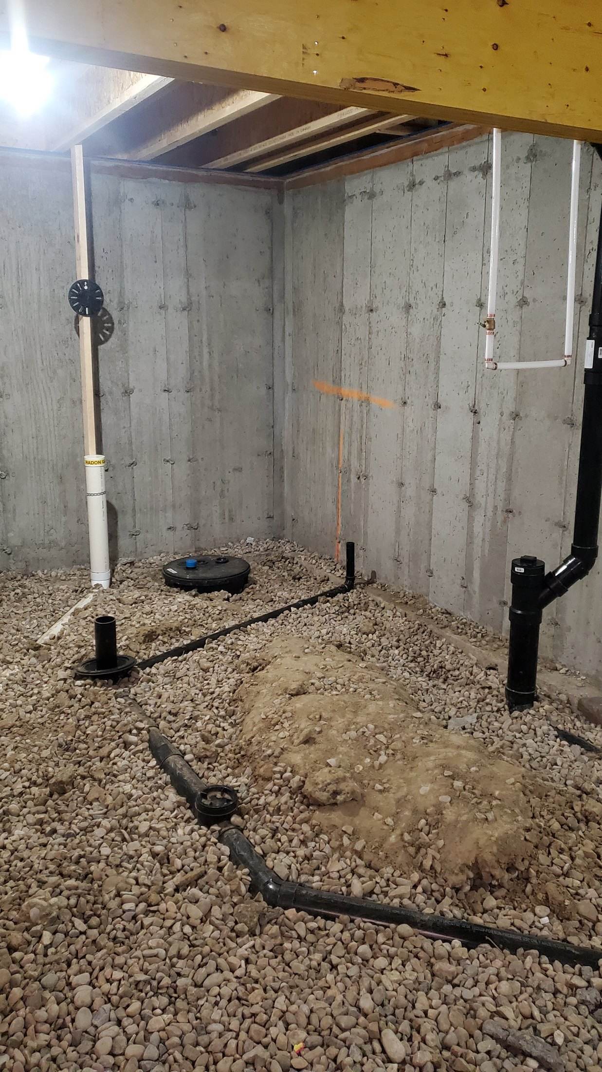 Under-slab drainage and PEX water lines for a Calgary basement bathroom