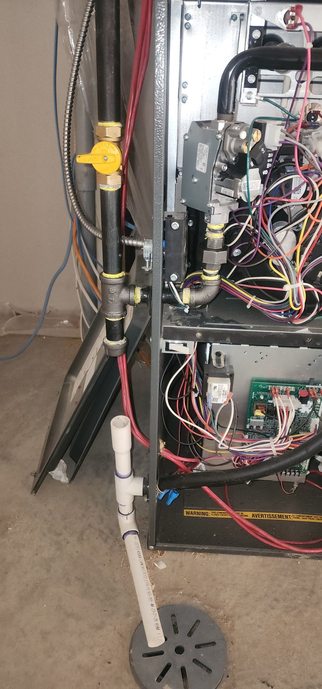 Licensed gas fitter connecting a residential gas appliance in Calgary
