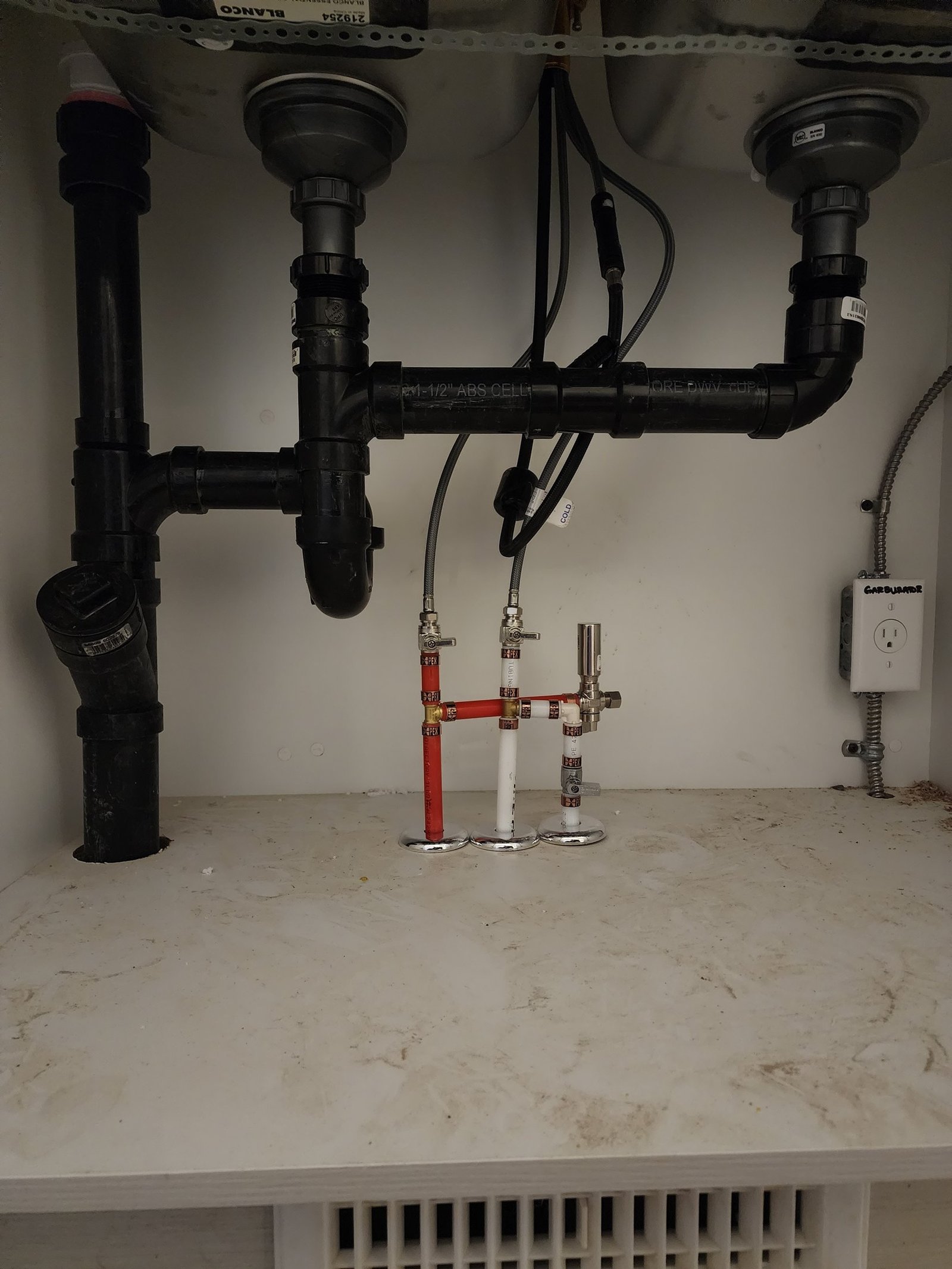 Under-sink kitchen plumbing connections completed by Flow Forge Calgary