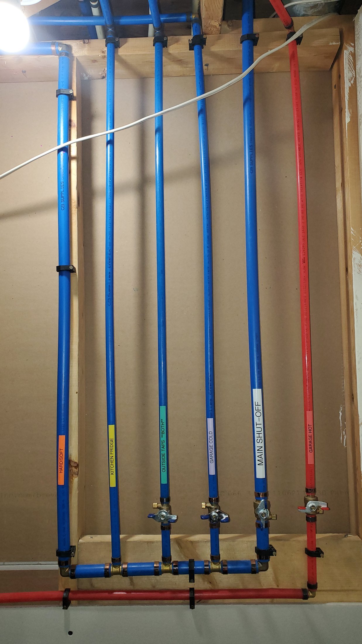 New PEX manifold replacing old Poly-B plumbing in a Calgary home